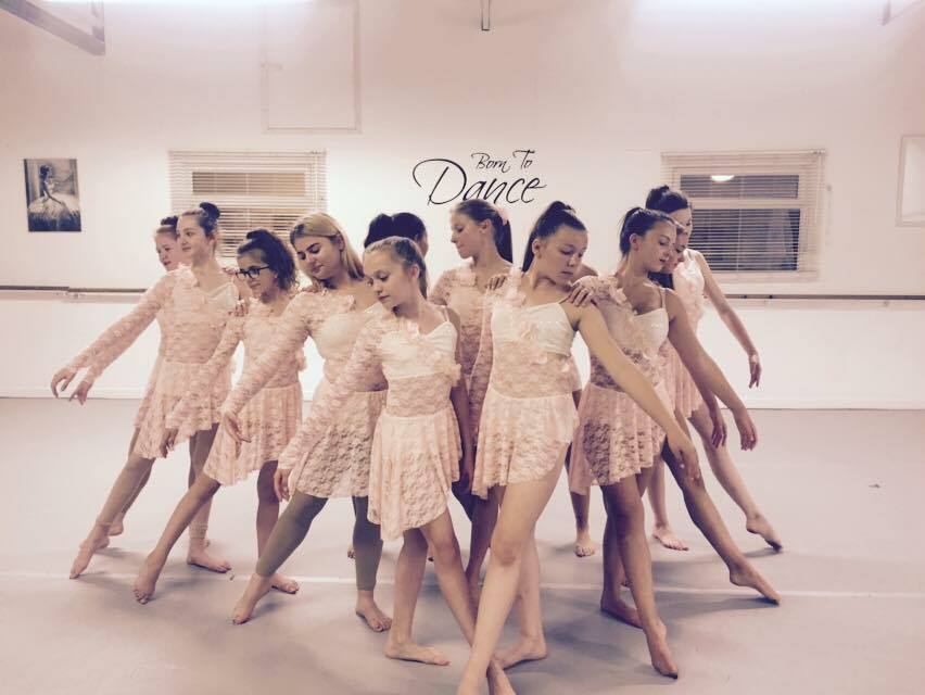 Ingram Academy dancers in pink costumes posing in the studio