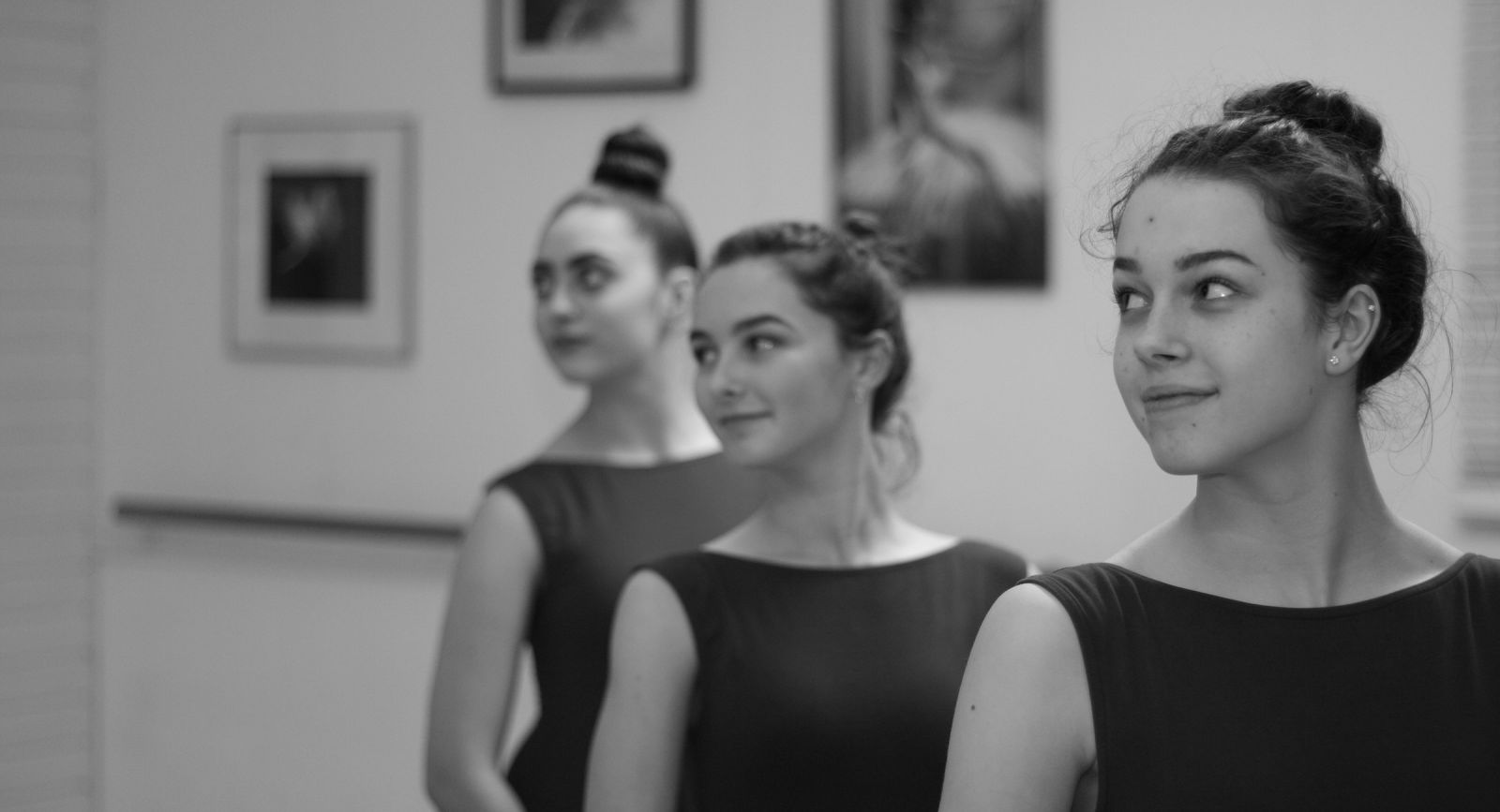 Three senior dancers in the Ingram Academy studio, photographed in black and white