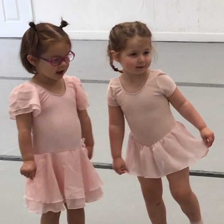 Two toddlers in pink leotards at their first ballet class